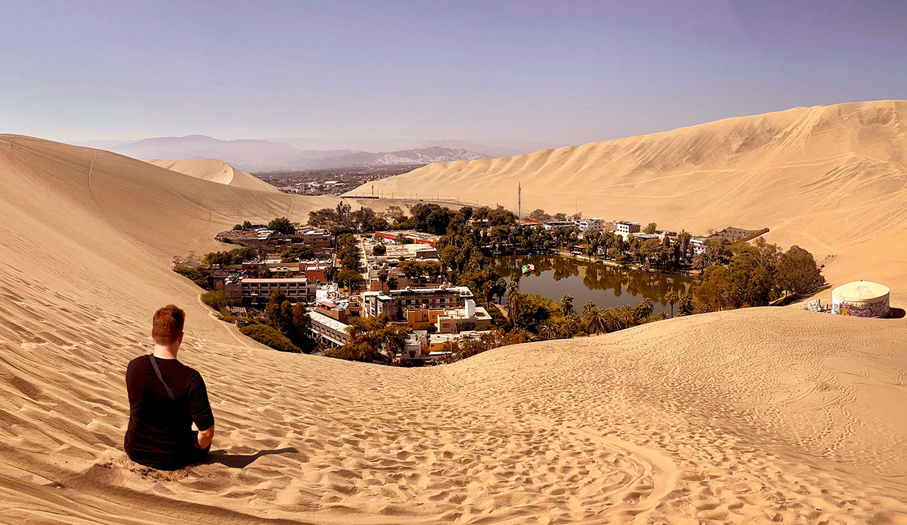 Sitting in the sand at Huacachina