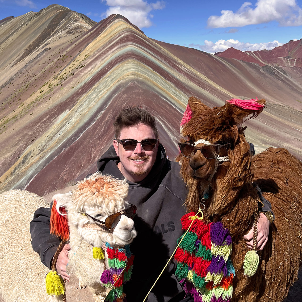 Luc Houle with two llamas at Rainbow Mountain