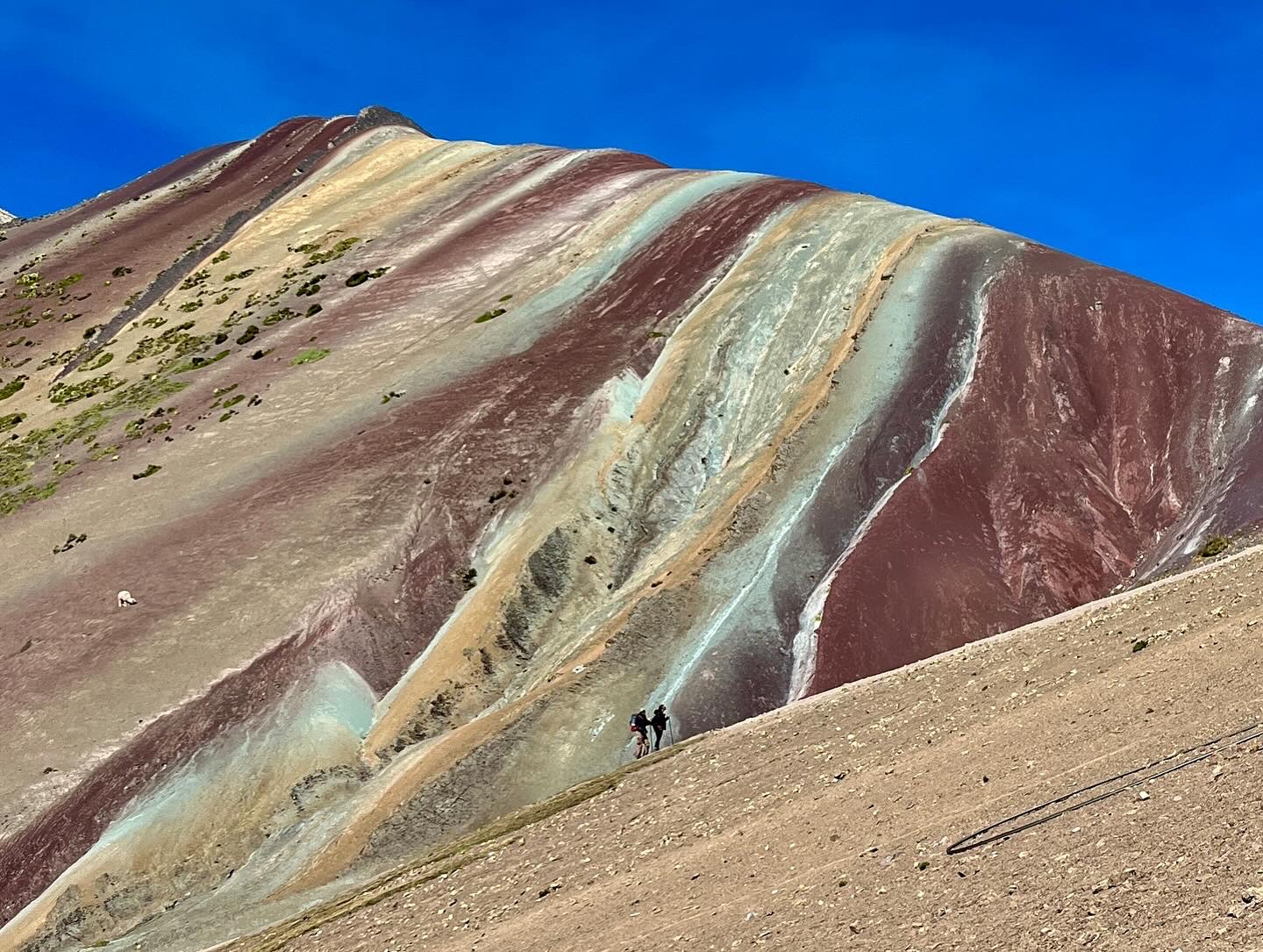 Two climbers scaling Rainbow Mountain