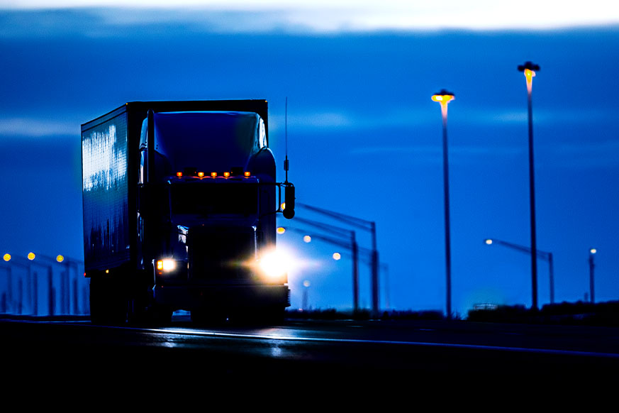 A transport truck driving down the road